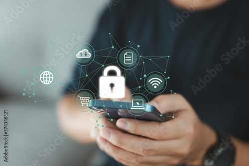 businessman using his smartphone to establish a network connection that is protected by a shield guard, which serves to prevent cyber attacks. concept of network security systems.