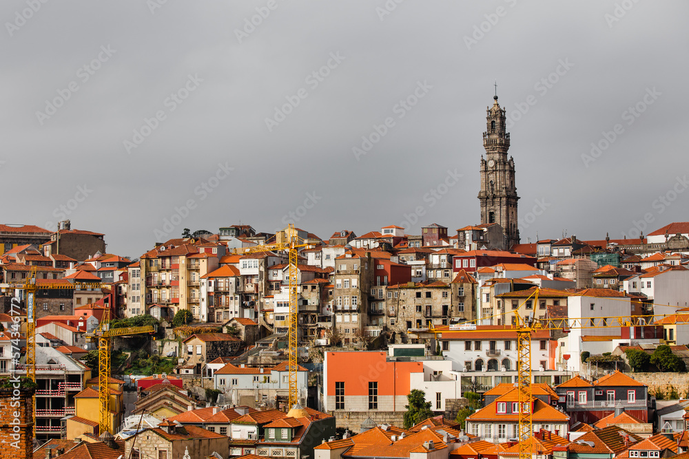 Bell tower at The Clérigos Church amidst orange rooftops in Porto