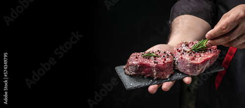 Photos Beef medallions with rosemary and spices, Raw beef meat steak Tenderloin fillet on a dark background