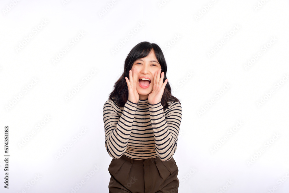 Happy young asian woman, professional entrepreneur standing in casual clothing, open mouths raising hands shout announcement, white background Happy young asian woman, professional entrepreneur standing in casual clothing, open mouths raising hands shout announcement, white background
