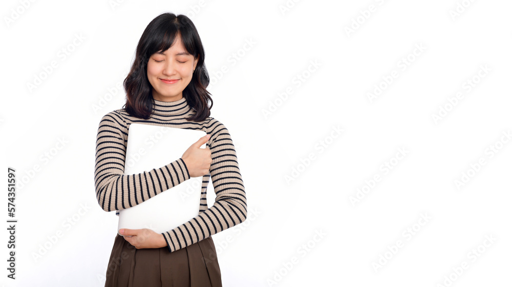 Beautiful young Asian woman on sweater clothing holding laptop pc computer and looking at camera with smile face, isolated on white background Beautiful young Asian woman on sweater clothing holding laptop pc computer and looking at camera with smile face, isolated on white background