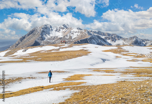 Ovindoli (Abruzzo, Italy) - The Monte della Magnola is a imponent and suggestive mountain peak in Abruzzo region, above the ski resorts of Ovindoli, here during the winter with snow and hiker. photo
