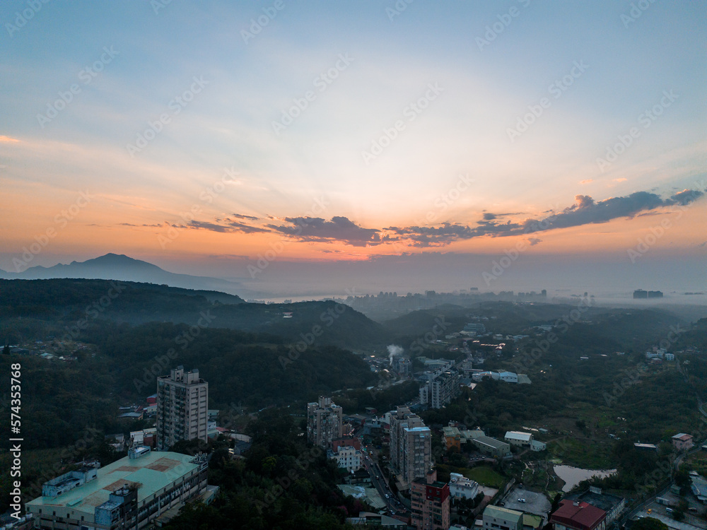 Aerial drone landscape shot of Tamsui, New Taipei City, Taiwan with beautiful sunset.