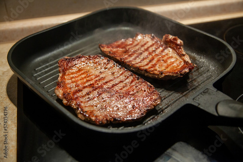 Raw minute steak of marbled beef in a grill pan