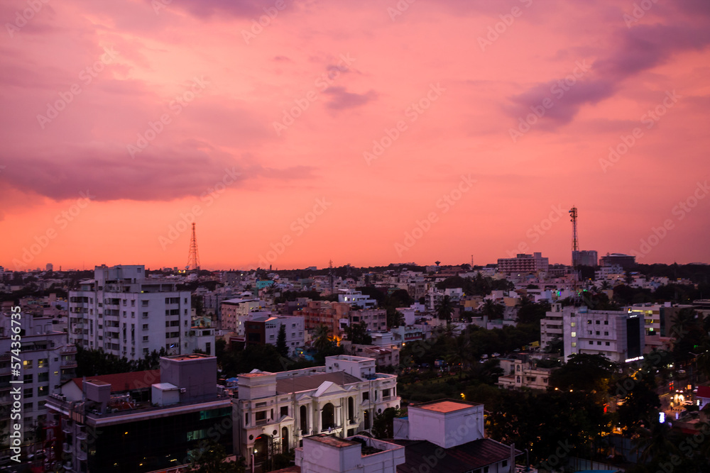 Bengaluru or Bangalore modern Cityscape at sunset with beautiful pink skyline,clouds,colors ,business buildings exterior architecture,residential apartments and commercial hub