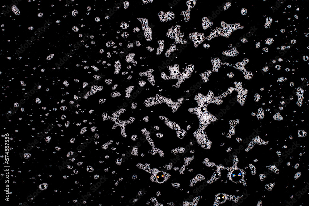 Splashes of white foam on a black background. Splashes of white foam on a black background.