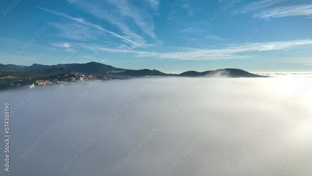 Aerial view, flight above the clouds, the coast of Mallorca in the fog with the town of Santa Ponca, Mallorca, Spain Aerial view, flight above the clouds, the coast of Mallorca in the fog with the town of Santa Ponca, Mallorca, Spain