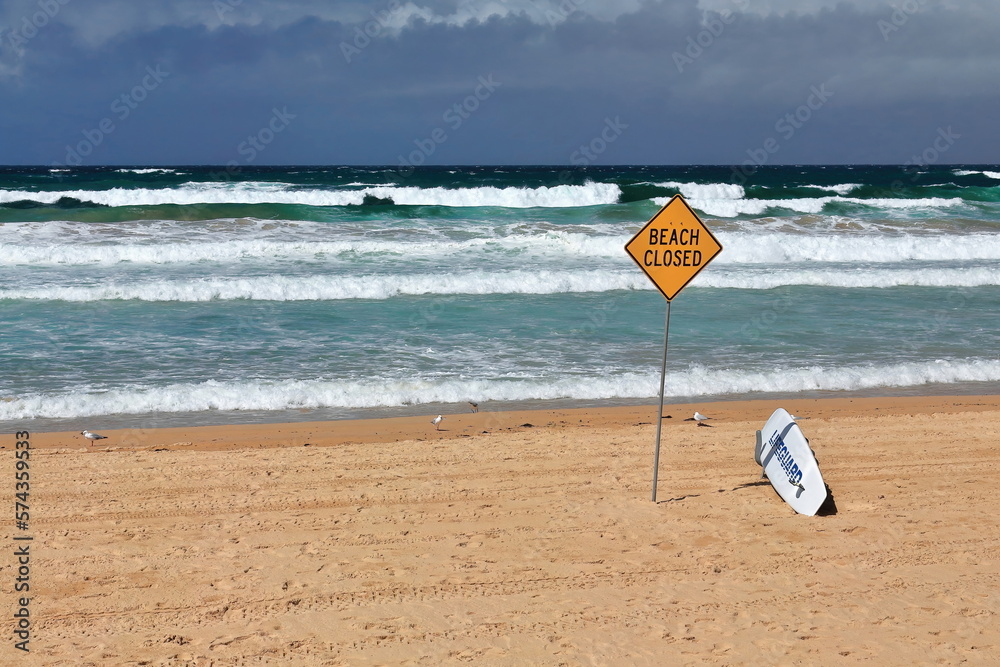 Manly Beach closed due to bad sea conditions-yellow signpost and white lifguard board. Sydney-Australia-503 Manly Beach closed due to bad sea conditions-yellow signpost and white lifguard board. Sydney-Australia-503