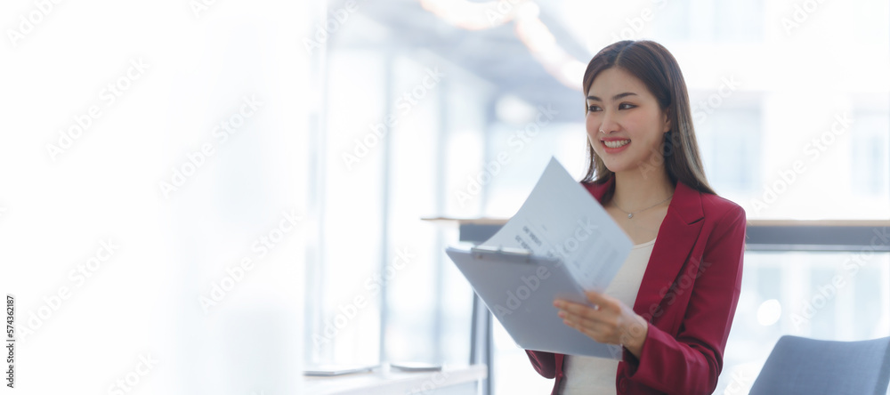 Attractive asia busy business woman consultant auditor working at modern office with balance sheet accounting bookkeeping documents. Account verification to prevent fraud bribery.