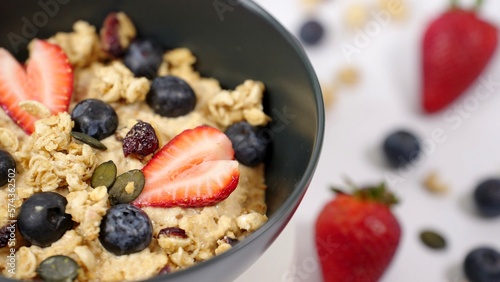 Healthy breakfast  vegan food concept oatmeal porridge bowl with stawberry   blueberry and grains. Clean eating  dieting