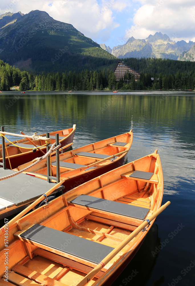 wooden boats on a pier in a mountain lake