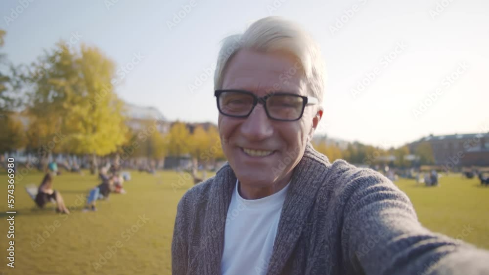POV shot of happy senior man talk on video chat outdoors. Realtime POV shot of happy senior man talk on video chat outdoors. Realtime