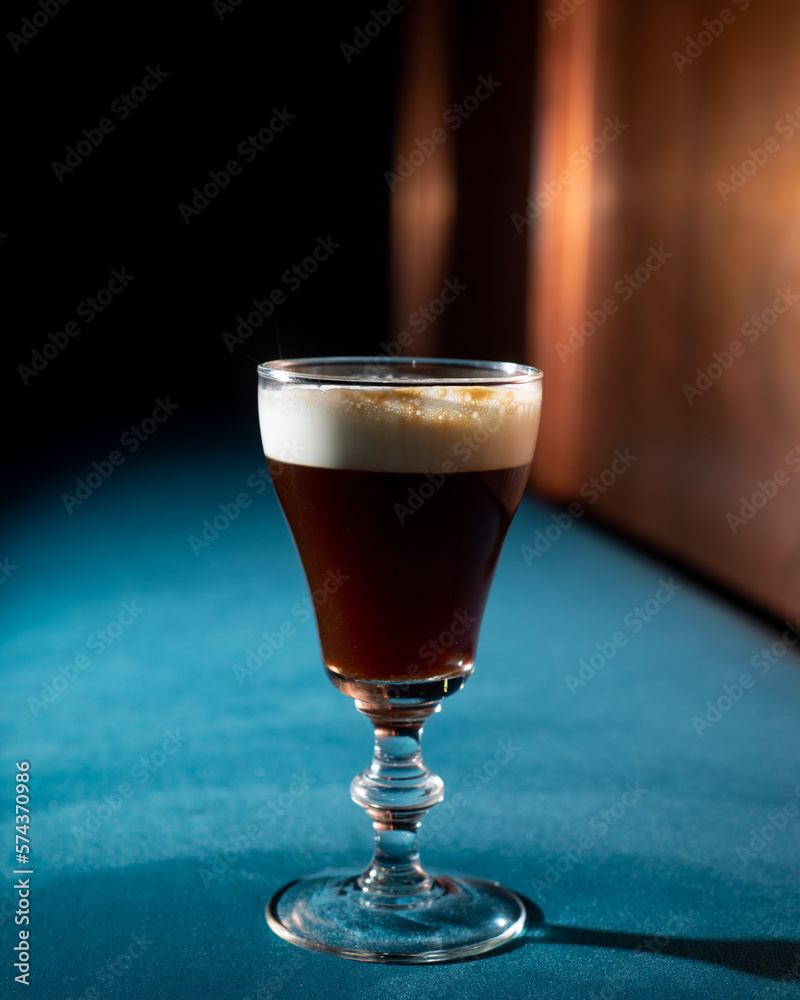 Brown cold brew coffee cocktail with cream and ice Brown cold brew coffee cocktail with cream and ice