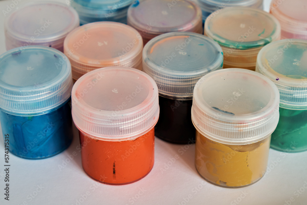 Closed cans with gouache of different colors. Drawing hobby. We learn to draw. Gouache paints. Closed cans with gouache of different colors. Drawing hobby. We learn to draw. Gouache paints.