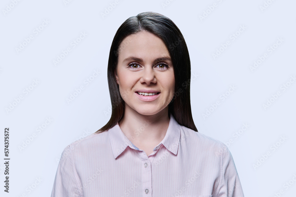 Headshot portrait of young woman in pink shirt on white background Headshot portrait of young woman in pink shirt on white background