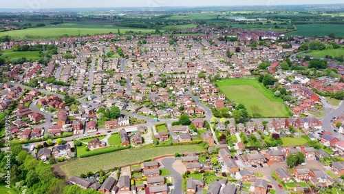 Aerial footage of the British town of Ossett, a market town within the metropolitan district of the City of Wakefield, West Yorkshire, England showing typical UK housing estates and roads photo