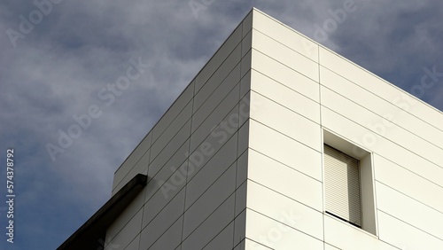 white facade corner against the sky