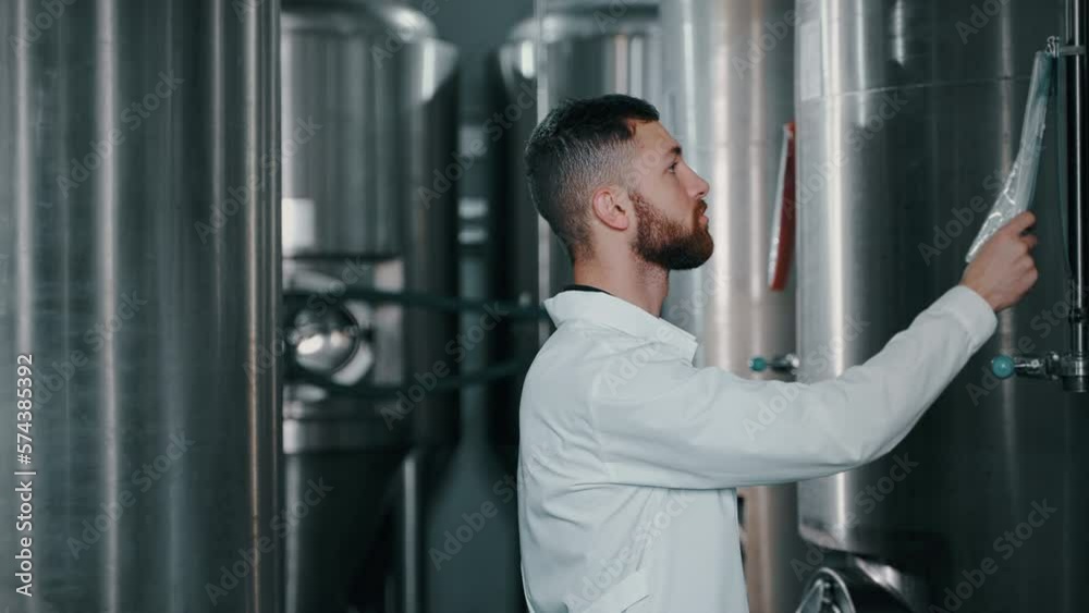 Food factory worker checking processing tanks