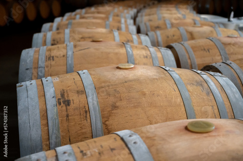 Rows of french and american oak barrels in cellars of winery in Rioja wine making region, Spain