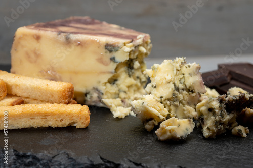 Cheese collection, blue stilton English cheese matured in red porto wine served as dessert with walnuts and chocolate