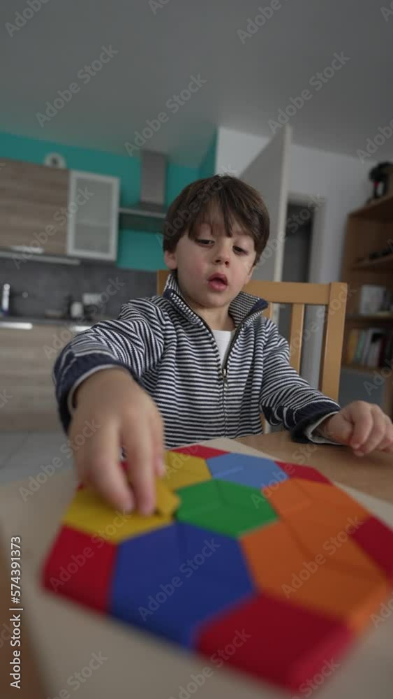 Creative child playing with puzzle blocks at home. One small 3 year old boy learning to play by himself at home apartment interior in Vertical Video Creative child playing with puzzle blocks at home. One small 3 year old boy learning to play by himself at home apartment interior in Vertical Video
