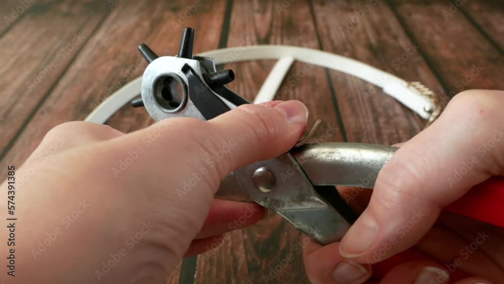 The process of manufacturing a leather belt by tanner. Puncture holes