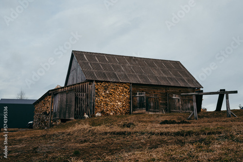 old wooden house stands against the gray sky