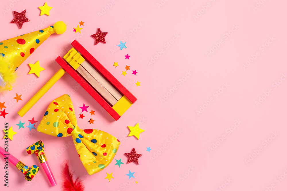 Purim carnival frame with traditional cookies, costume accessories and decor on pastel pink background Purim carnival frame with traditional cookies, costume accessories and decor on pastel pink background