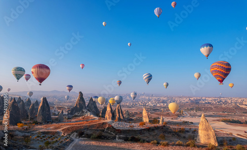 Landscape sunrise with hot air balloons fly over deep canyons, valleys Cappadocia Goreme National Park Turkey, aerial top view