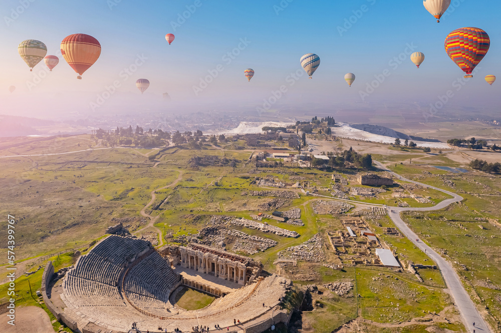 Concept Travel Pamukkale Turkey. Hot air balloon flying Travertine pool ancient amphitheater
