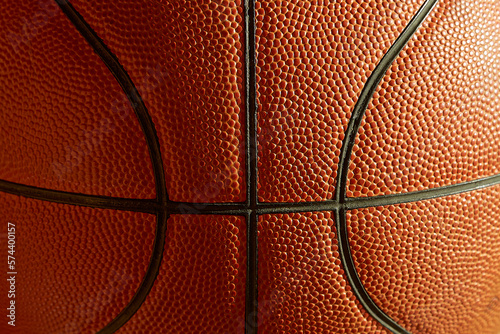 Fragment of a basketball in the sunlight close-up, macro © Александр Ланевский