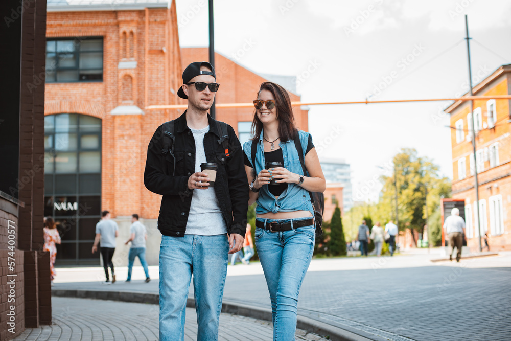 young stylish couple walks around city with sunglasses. Walk sights date guy girl.