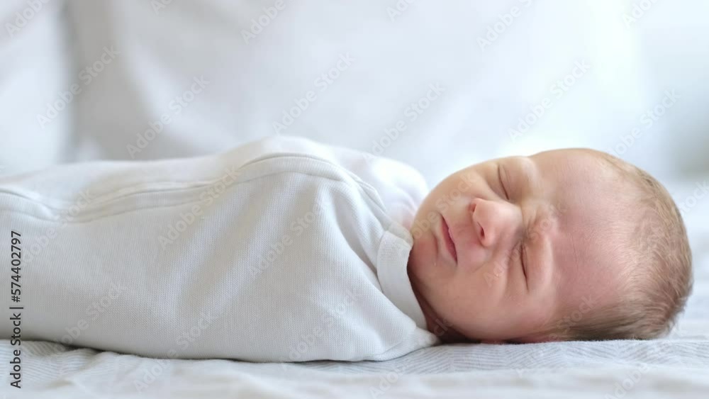 Cute adorable newborn baby boy lying on stomach on white bed at home sleeping, awaking, moving. Purity,innosence concept.Full body, Cute adorable newborn baby boy lying on stomach on white bed at home sleeping, awaking, moving. Purity,innosence concept.Full body,