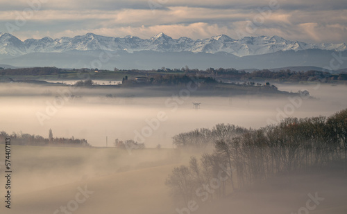 Sunrise in the mist in the Gers department in France with the Pyrenees in the background