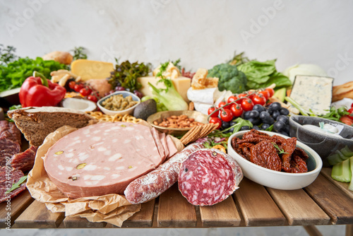 Salami and Parma sausage close-up. Table full of mediterranean appetizers, tapas or antipasto. Assorted Italian food set. Delicious snack on party or picnic time. Meat and cheese. Italian style