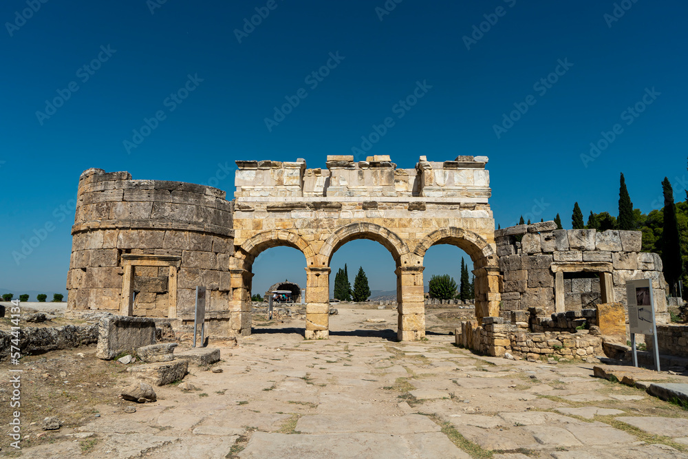 View of the Northern Roman Gate, part of a fortification system, in Hierapolis, Pamukkale, Denizli, Turkey with two towers. Frontinus Gate. Copy space for text. View of the Northern Roman Gate, part of a fortification system, in Hierapolis, Pamukkale, Denizli, Turkey with two towers. Frontinus Gate. Copy space for text.