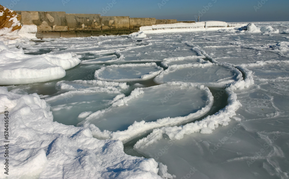 The Black Sea is frozen, ice floes float along the shore. Climate change, harsh winter
