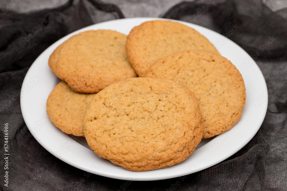Few homemade cookies on white small dish Few homemade cookies on white small dish