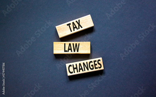 Tax law changes symbol. Concept words Tax law changes on wooden blocks on a beautiful black table black background. Business tax law changes concept. Copy space.