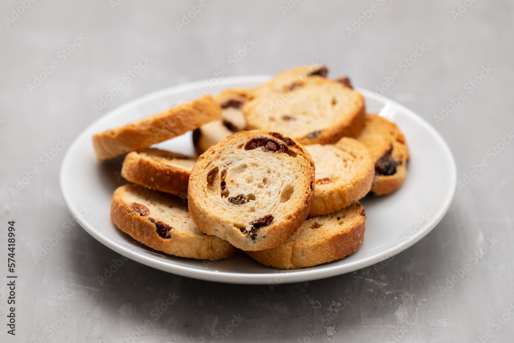 Mini round toasts of bread with raisins on dish