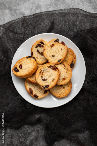 Mini round toasts of bread with raisins on dish