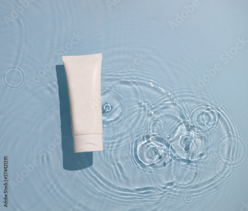 Skin care product mock up on water surface. Water ripples from top angle. Flat lay of ocean waves with product in centre. 