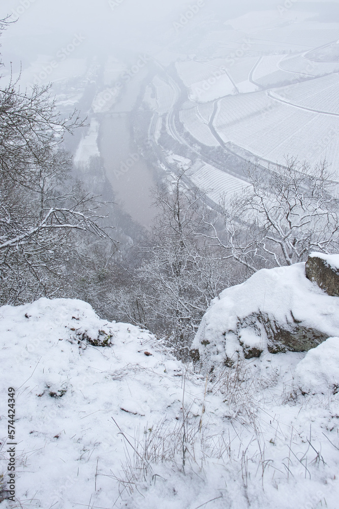 Edge of a mountain overlooking the Nahe river and farmland on a foggy, snowy day in the Palatinate Forest of Germany. Edge of a mountain overlooking the Nahe river and farmland on a foggy, snowy day in the Palatinate Forest of Germany.