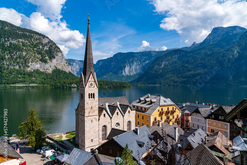 Hallstatt historical village panorama, Austria. Medieval European architecture in sunny summer day. Hallstatter see, mountains and blue sky in background. 