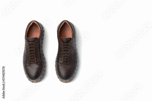 Dark brown leather men's sporty boots with thick soles on a white background. Copy space.