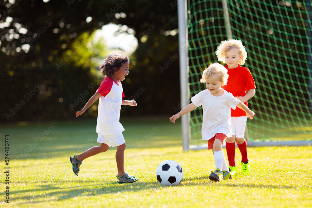 Kids play football. Child at soccer field. Kids play football. Child at soccer field.