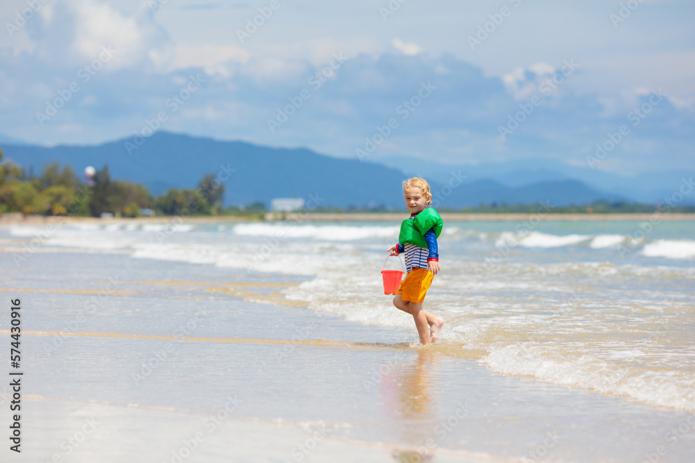 Kids play on tropical beach. Sand and water toy. Kids play on tropical beach. Sand and water toy.