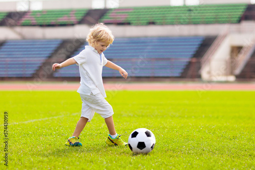 Kids play football. Child at soccer field. © famveldman