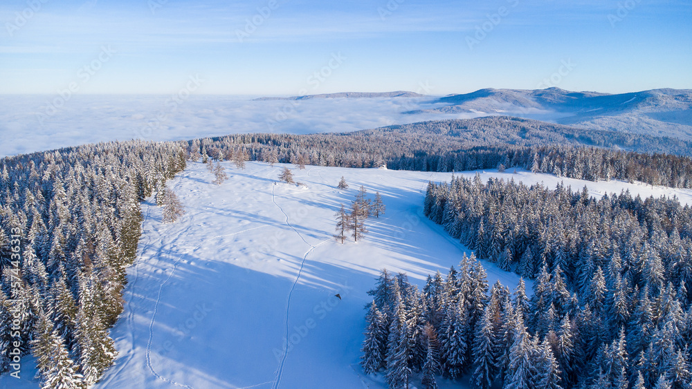 Beautiful winter scenery seen from the air with blue sky and powder snow