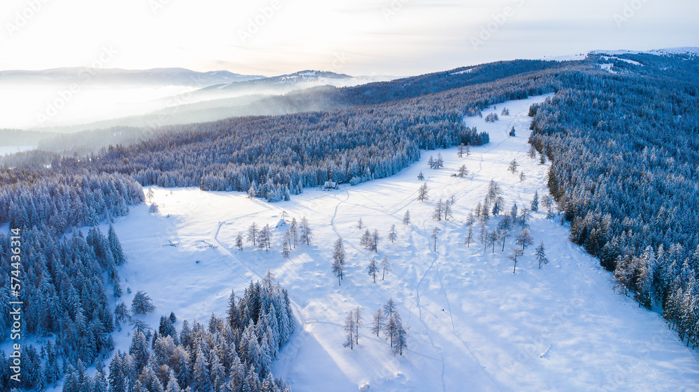 Beautiful winter scenery seen from the air with blue sky and powder snow